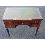 William IV mahogany breakfront ladies' writing table with an inset gilt tooled leather top and 4