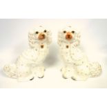 Pair of Victorian earthenware models of spaniels, each with painted detail, H.33cm. (2)