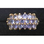 Foreign 9ct gold ring with a triple row of lavender blue stones, imported by QVC, Birmingham,