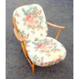 Ercol beech spindle back open armchair on turned tapering legs and a similar smaller chair. (one
