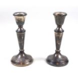 Pair of silver candlesticks, each with a tapering cylindrical column, on a reeded circular base,