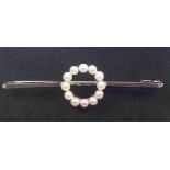 9ct white gold bar brooch mounted with a roundel set seed pearls, L.4.5cm, gross 2.2grs and a ring