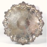Victorian silver shaped circular salver with an engraved monogram within a scrolling floral border