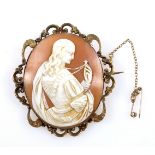 Italian carved shell oval cameo brooch of a Classical woman holding a cross, signed “Lamont J”, in a