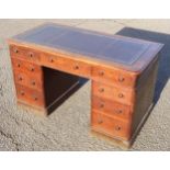 Victorian oak pedestal desk with 9 drawers and an inset gilt tooled burgundy leather top on a plinth