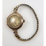 George V 9ct gold lady's wrist watch with a hinged lens and back, and a circular dial enclosing a