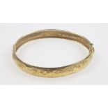 9ct gold hinged bracelet with engraved floral decoration, gross 7.3grs