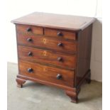 George IV mahogany chest of small proportions with 2 short and 3 graduated long drawers, on ogee