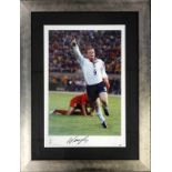 A signed photograph of Wayne Rooney, in a glazed frame, the reverse also signed by Nobby Stiles