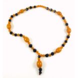 Necklace with amber oval and spherical beads and jet faceted beads, L.64cm less pendant, 77.5grs, (