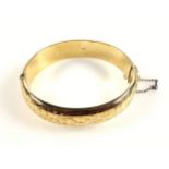 9ct gold floral engraved hinged bracelet by J S, Birmingham, 1963, retailed by Bravingtons, 21.3grs