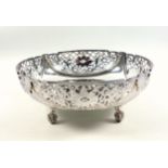 Silver circular bowl with swags and pierced scroll and floral decoration, on 4 involute scroll feet,