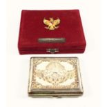 Thai presentation white metal cigar case, the parcel gilt hinged cover chased and embossed with