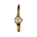 J W Benson 9ct gold lady's bracelet watch with a circular dial, gilt Arabic numerals enclosing a