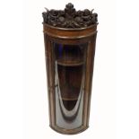 Edwardian small oak hanging bow fronted corner cabinet with a glazed panelled door and carved cherub