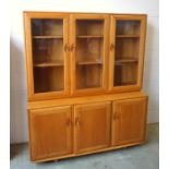 Ercol light elm side cabinet with 3 glazed panelled doors above and 3 panelled doors below, on
