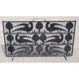 C F A Voysey style cast iron and wire mesh firescreen, the stylised design with 3 rows of flowers