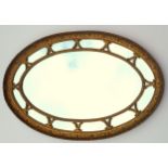 Edwardian style wall mirror with an oval plate within a mirrored border in a floral decorated frame,