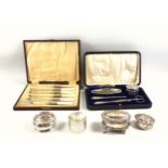 George V silver mounted manicure set, comprising nail buffer, file, pick, silver mounted glass jar