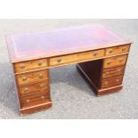 Edwardian mahogany pedestal desk with 1 long, 8 short graduating drawers, inset gilt tooled