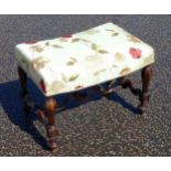William and Mary style rectangular stool with a floral upholstered saddle seat on walnut baluster