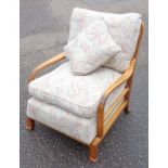 Pair of 1930s German walnut open armchairs each with a spindled back, patterned fabric loose seat