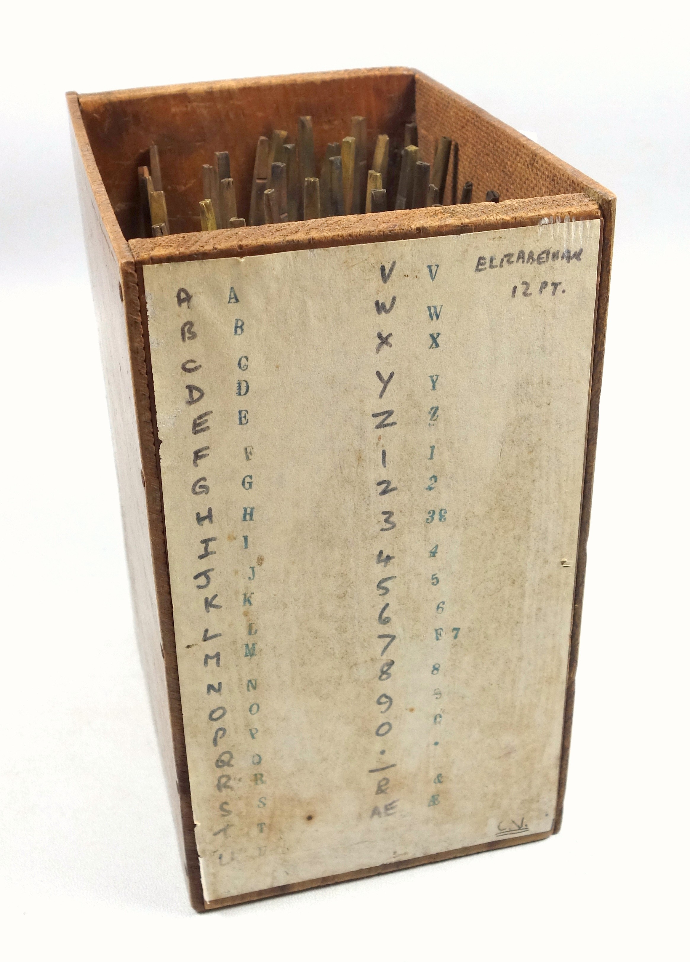 Wooden box containing 38 gold finishing hand tools comprising complete alphabet, numbers 0-9,