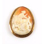 Oval shell cameo brooch carved with a seated woman and hound, in a yellow metal mount stamped "9ct",