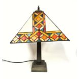 Tiffany style table lamp with a tapering square section metal column, on a stepped foot, and a