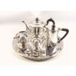 George V silver 3 piece tea set comprising circular teapot with raised leaf decoration, ebonised