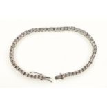 Foreign white metal bracelet with 57 box links, each set with a diamond, stamped "375", L.18cm, 11.