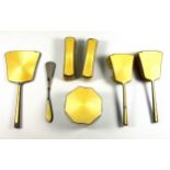 George V silver and yellow guilloche enamel 7 piece dressing table set comprising 2 hair brushes,