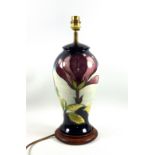 Moorcroft Magnolia pattern lamp base, in the form of a baluster vase with cover, on a circular