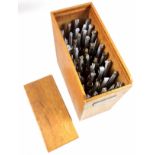 Wooden box containing 40 gold finishing hand tools comprising complete alphabet, numbers 1-9,