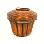 Victorian copper blancmange mould of tapering cylindrical form with a fluted body, swirl top and