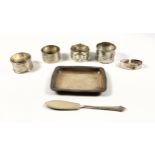 George V silver shaped rectangular pin dish by Elkington & Co., Birmingham, 1912; 3 napkin rings,