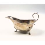 Elizabeth II silver sauceboat with shaped rim, flying scroll handle, on 3 hoof feet, by A Chick &