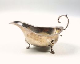 Elizabeth II silver sauceboat with shaped rim, flying scroll handle, on 3 hoof feet, by A Chick &