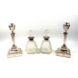 Pair of Edwardian silver candlesticks with an urn shaped sconce, square section tapering column,