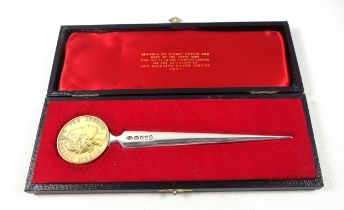 Elizabeth II silver paper knife with a tapering blade, the terminal set with a medal commemorating