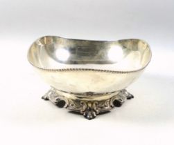 White metal pedestal elliptical bowl with a beaded rim, on an embossed foot, marked "Silver", W.19.