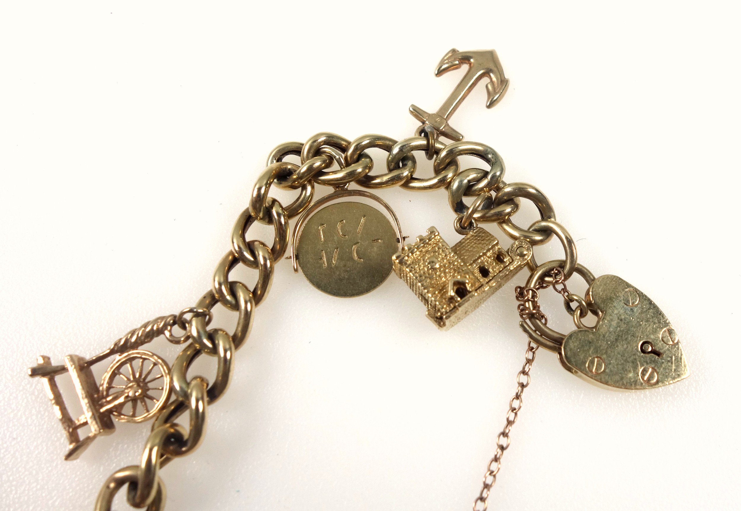 9ct gold curb-link bracelet with 11 9ct and yellow metal charms, 26.8grs - Image 2 of 4