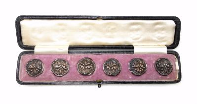 Set of 6 Edwardian silver Art Nouveau buttons, each with floral decoration in relief, by Henry