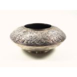 Thai white metal presentation vase of footed lenticular form, the upper half embossed with scrolling