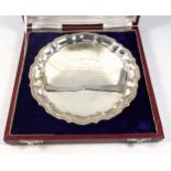 Indian white metal circular presentation salver with a beaded piecrust border, stamped "Silver",