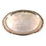 Indian white metal oval presentation salver with an embossed scrolling and gadrooned rim, marked "