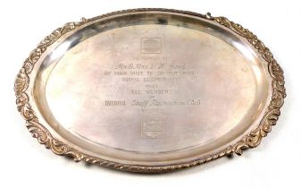 Indian white metal oval presentation salver with an embossed scrolling and gadrooned rim, marked "
