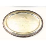 Thai white metal oval presentation dish, with an decorative embossed rim, on 4 bun feet, presented