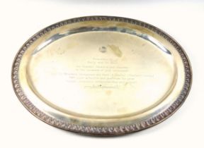 Thai white metal oval presentation dish, with an decorative embossed rim, on 4 bun feet, presented