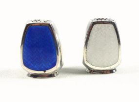 Pair of Danish silver and enamel pepperettes, one in blue and one in white, with foliate decoration,
